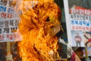 韓国保守派のデモで燃やされる金正恩氏の写真（2016年3月26日、ソウル／ニューシスKorea）